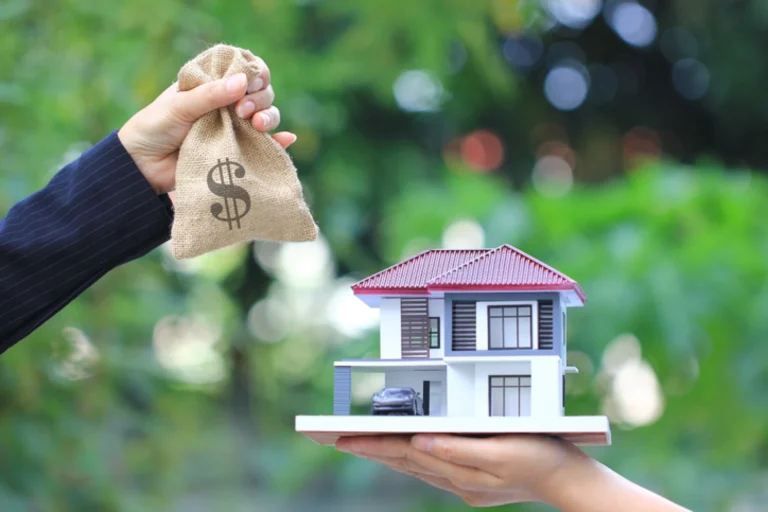 Casa en manos con bolsa de dinero